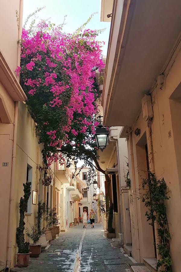 Beautiful alleyway in Rethymno, Crete with blooming flowers. 