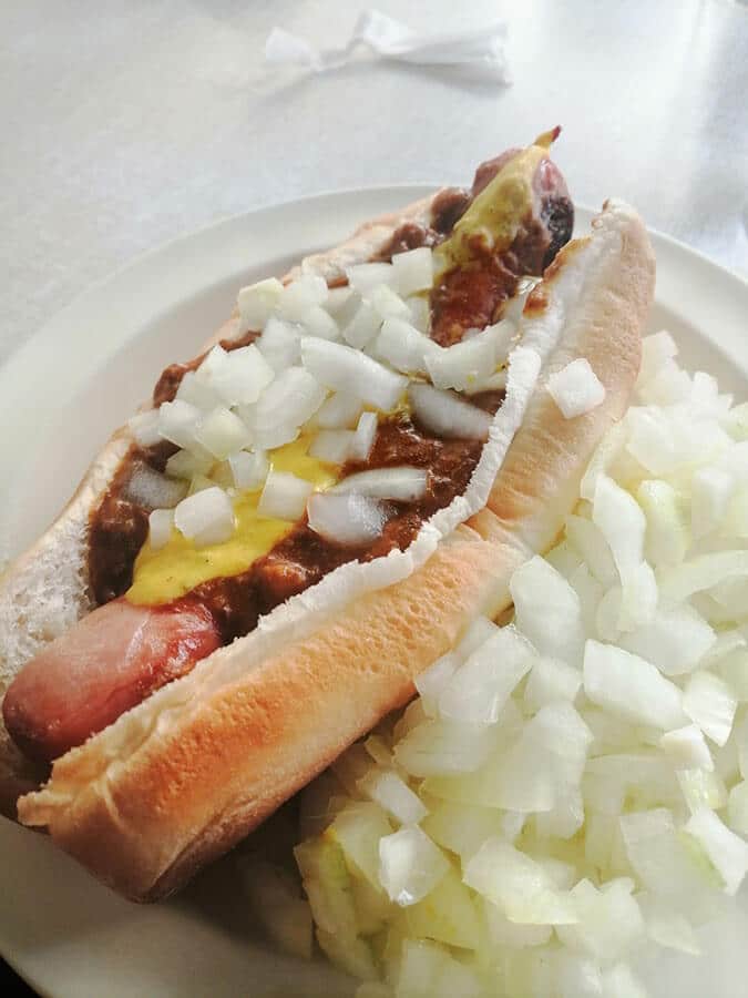 A Coney Island, a famous hot dog from Detroit made with chili, onions, mustard, and ketchup! 
