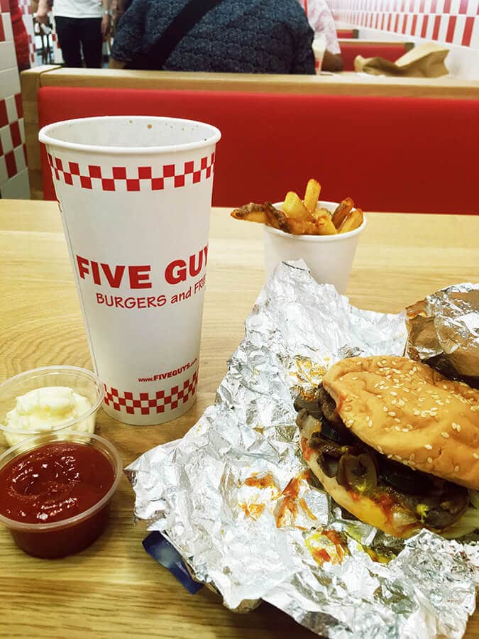 Hamburger and fries at Five Guys in the Hague, the Netherlands.  This American chain has good American food in the Hague. #travel #food #americana