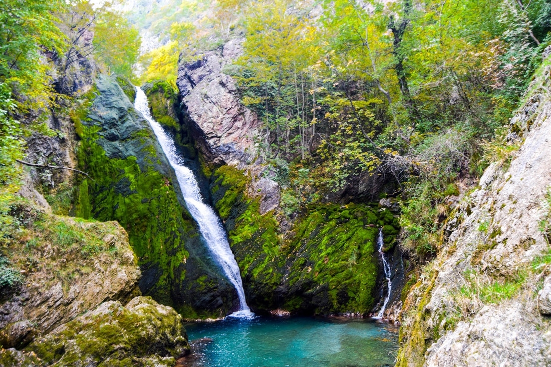 Beautiful waterfall with amazing blue water in Peja Kosovo. See why you should visit Kosovo via beautiful nature photographs. 