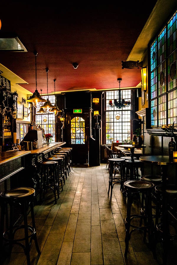 Interior of De Vergulde Kruik, a charming brown bar in Leiden worth visiting. This charming Dutch cafe in Leiden is where the Heineken Star originated from! #travel #leiden #heineken #holland #beer #nederland #netherlands