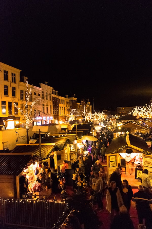 The beautiful lit up Leiden Christmas Market at night.  This floating Christmas market is perfect for foodies! #leiden #travel #holland #netherlands 