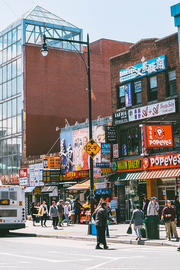 Busy street with signs in Chinese in Flushing, one of the largest Chinatowns in the world!  