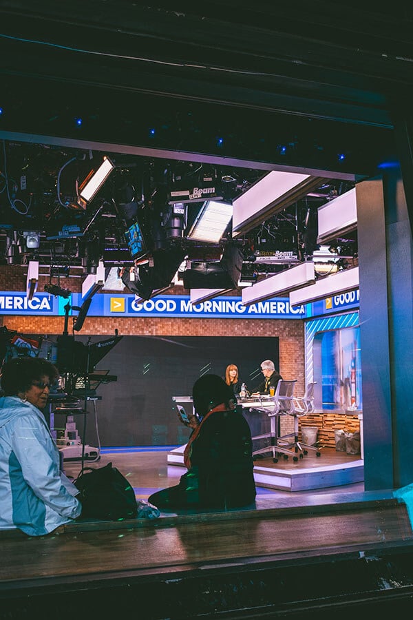 News anchors preparing for a broadcast in Times Square