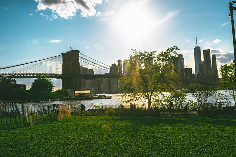 Sunset at Brooklyn Bridge Park with a view of Brooklyn Bridge, one of the best cheap things to do in New York City.