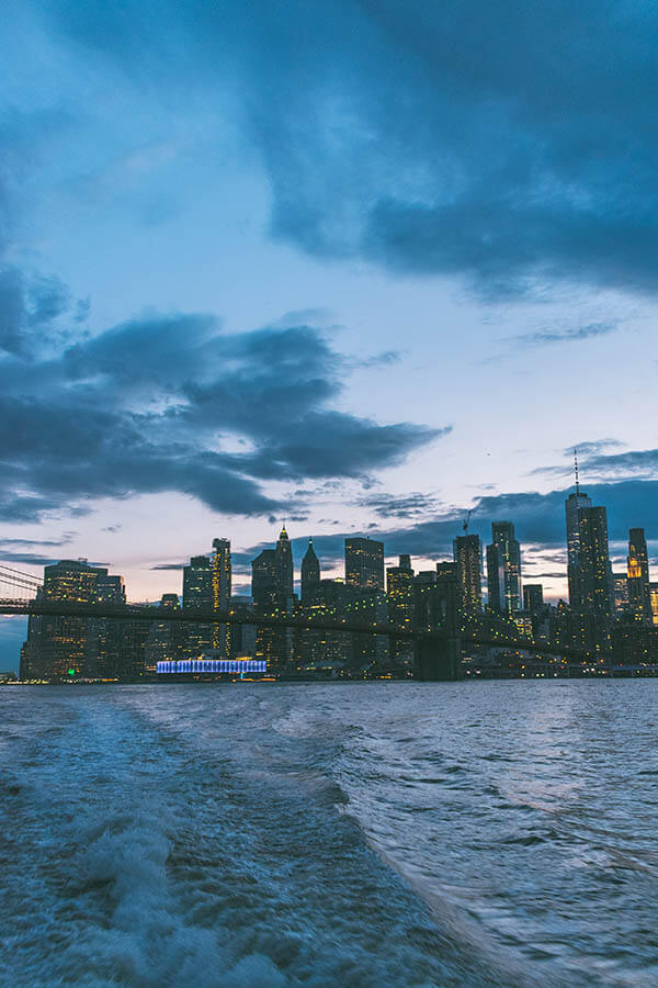 Beautiful view of Manhattan at dusk with sunset hues seen from the NYC ferry from Brooklyn