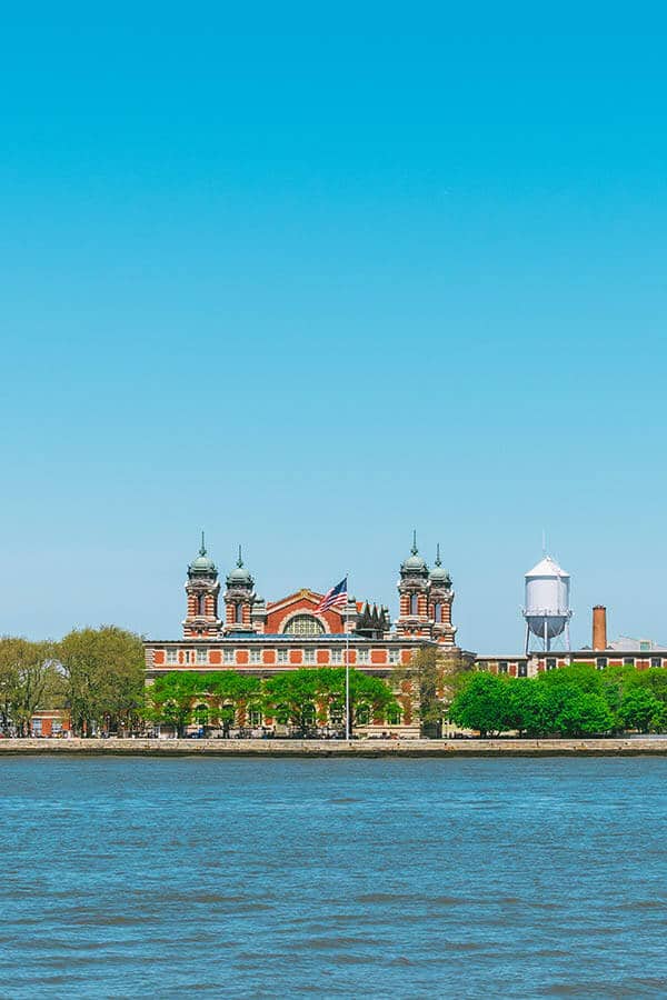 Ellis Island seen from the Statue of Liberty ferry on a beautiful sunny day.