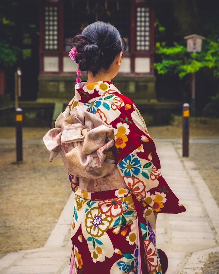 Photo of girl at a shrine in Kyoto. Read tips for the best shrines in Kyoto to visit for getting off the beaten path in Kyoto with tips for visiting the most beautiful temples in Kyoto. #travel #kyoto #japan #asia