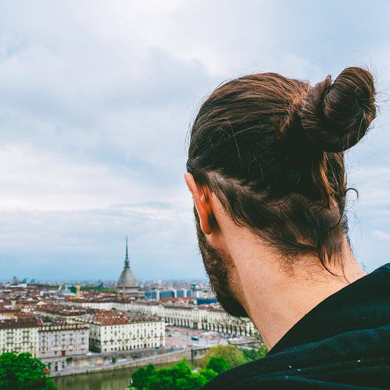 Man enjoying a beautiful view of Turin from a nearby mountain