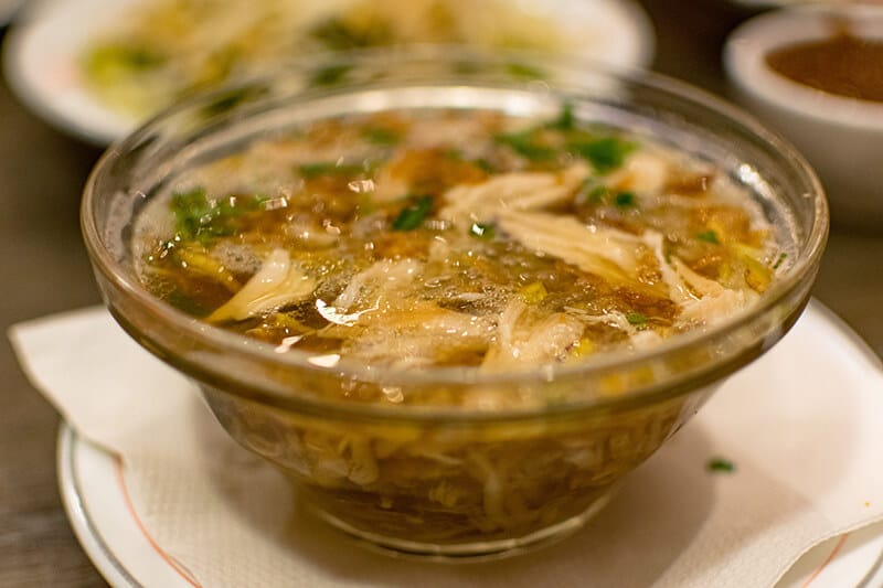 Saoto, a popular Surinamese soup that is served with chicken broth, noodles, and vegetables, served at a surinamese restaurant in the hague.