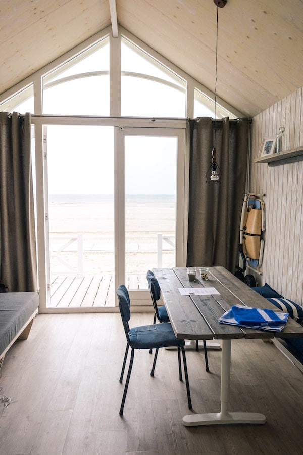 View of the beach from inside the Haagse Straandhuisjes, one of the luxurious options for hotels near Scheveningen! #travel #hotels #beach #holland