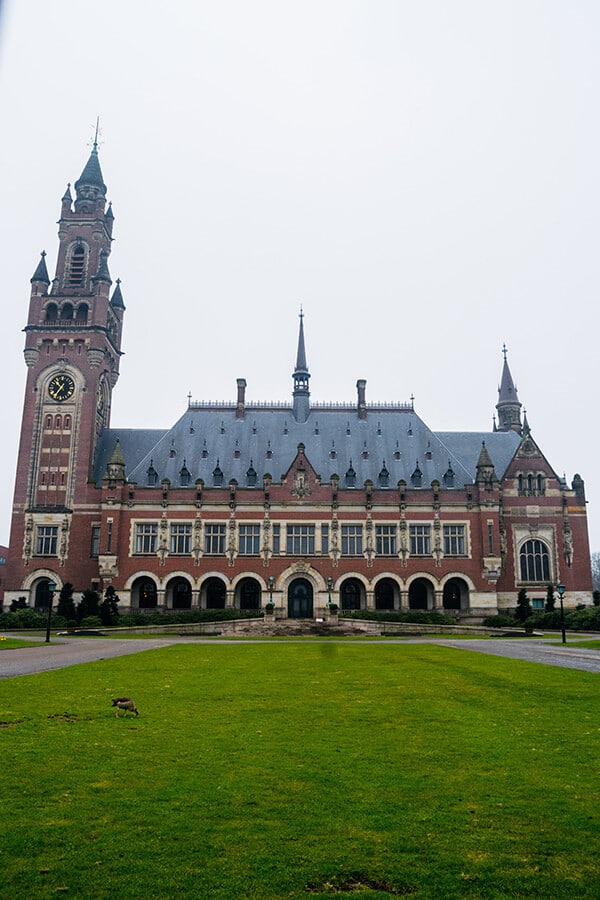 Peace Palace in the Hague seen from the sidewalk.  This self-guided biking tour of the Hague covers the major highlights of the Hague for first time visitors interested in politics! #travel #netherlands #holland #hague #denhaag