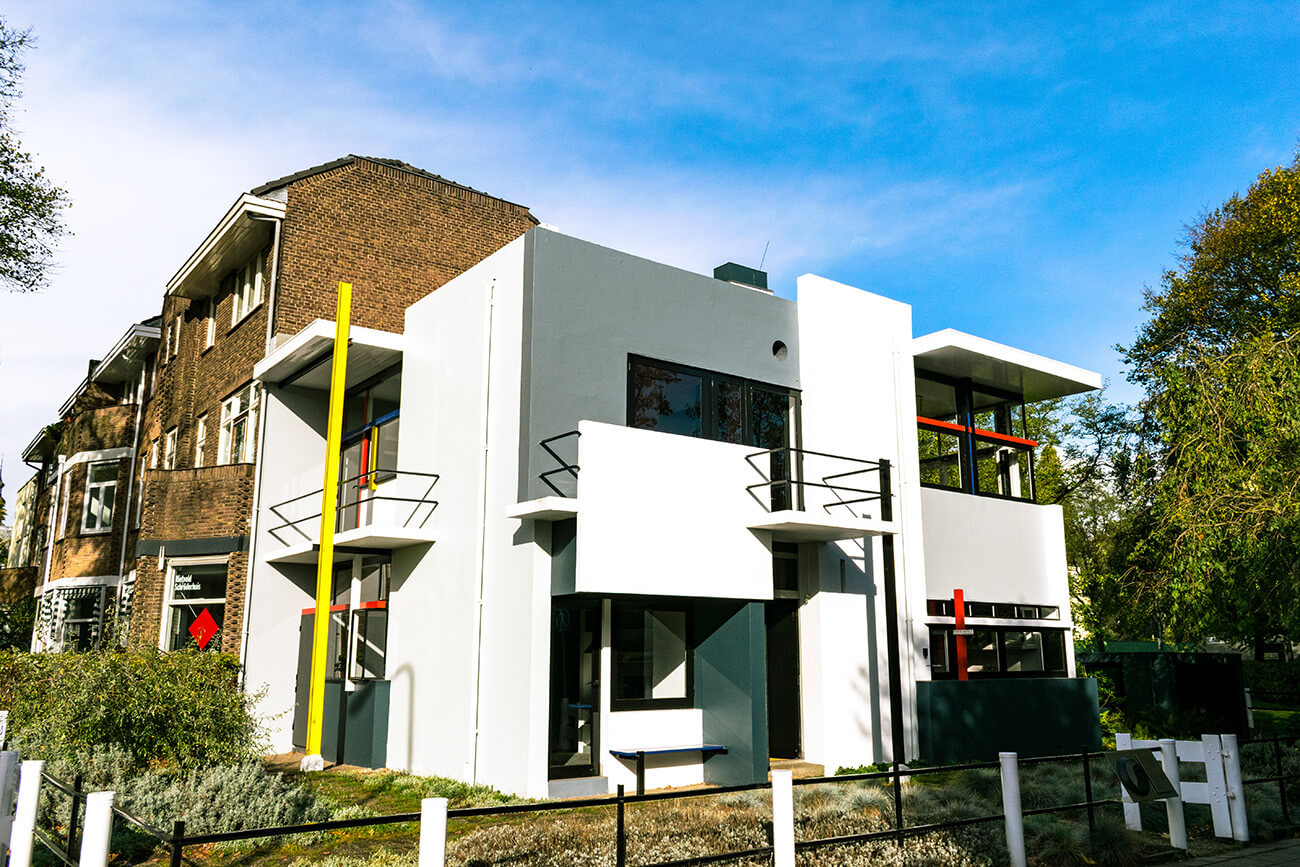 The beautiful white, yellow, and red exterior of the Rietveld Schröderhuis.  This icon of De Stijl in Utrecht is a must-see for architecture lovers! #architecture #destijl #netherlands #design