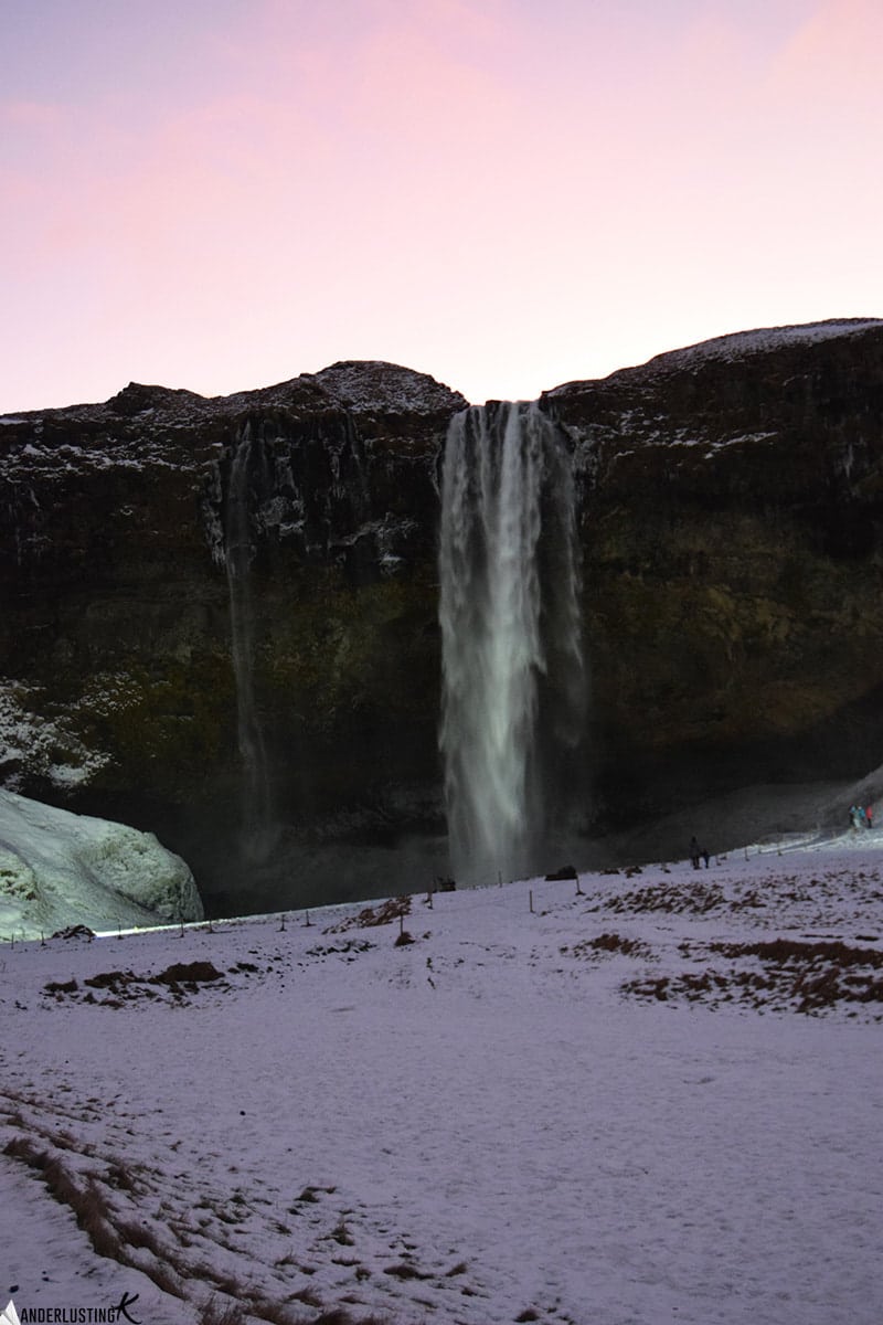 Photo of Seljalandsfoss waterfall in Iceland. Find out what it's like to take a iceland road trip in winter with tips for driving in iceland in winter.