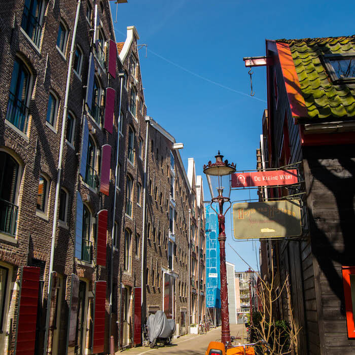 Beautiful old warehouses along Prinseneiland in Amsterdam.  This beautiful neighborhood (westelijke eilanden) in Amsterdam is worth exploring! #travel #netherlands #holland #amsterdam