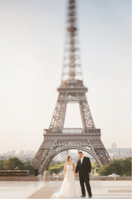 Romantic photo of couple underneath Eiffel tower in Paris. For more French wedding inspiration, find out more about elopements in France.